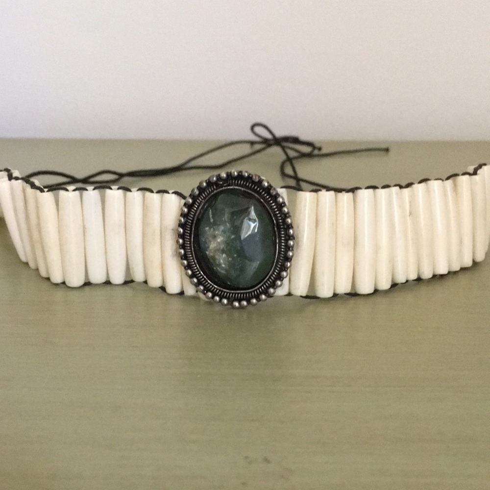 Striking choker with stone centerpiece. Cord tie for sizing.